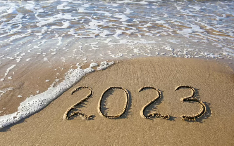 2023 year written sandy beach sea top view flat lay